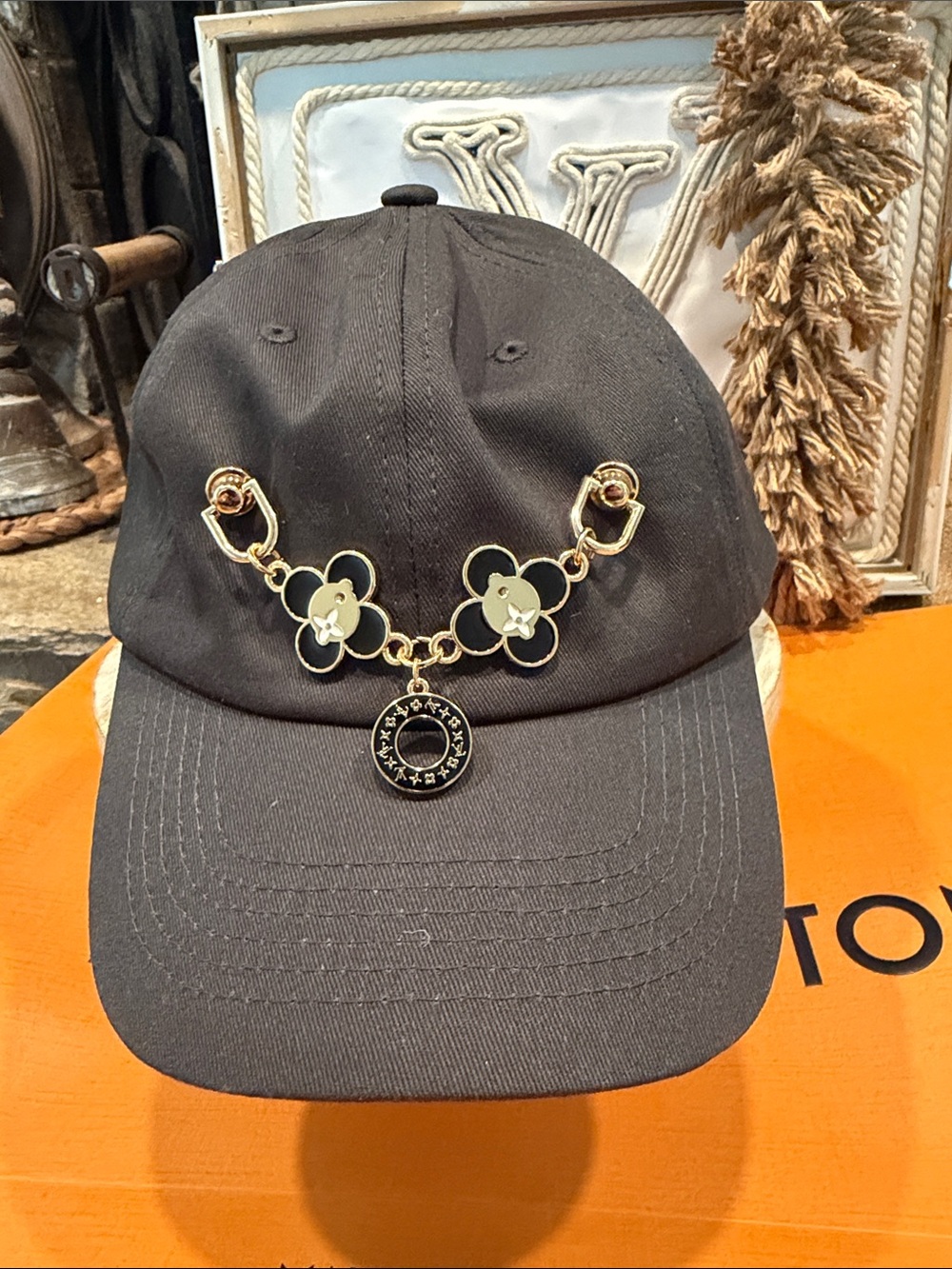 Handcrafted Black Cap with Gold Floral Chain Detail and charm